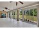 Bright sunroom with tiled floor, ceiling fans and multiple sliding glass doors to the backyard at 1724 Arbor Hill Rd, Canton, GA 30115