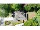 Aerial view of a grey roof, two story home, surrounded by beautiful trees and a long white driveway at 23 Long Island Pl, Sandy Springs, GA 30328