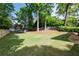 Large backyard featuring a sprawling lawn, mature trees, a trampoline, and ample space for recreation at 23 Long Island Pl, Sandy Springs, GA 30328