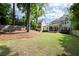 Expansive backyard with lush lawn, mature trees, and privacy fence providing outdoor enjoyment at 23 Long Island Pl, Sandy Springs, GA 30328