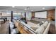 Finished basement features a home theater, brick accent wall, and comfortable seating at 23 Long Island Pl, Sandy Springs, GA 30328