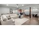 Basement area with large sectional sofa, game tables, and wooden support beams at 23 Long Island Pl, Sandy Springs, GA 30328