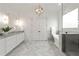 Luxury bathroom featuring a soaking tub, glass-enclosed shower, and double vanity with marble countertops at 23 Long Island Pl, Sandy Springs, GA 30328