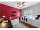 Inviting bedroom with a colorful accent wall, wood floors, and natural light at 23 Long Island Pl, Sandy Springs, GA 30328