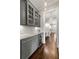 Butler's pantry with ample counter space, custom cabinets, wine cooler and hardwood floors at 23 Long Island Pl, Sandy Springs, GA 30328