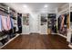 Spacious walk-in closet featuring custom shelving, dark hardwood floors, and ample storage at 23 Long Island Pl, Sandy Springs, GA 30328
