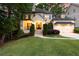 Charming home with a manicured lawn, inviting entrance, and attached garage, offering a warm and welcoming curb appeal at 23 Long Island Pl, Sandy Springs, GA 30328