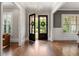 Light-filled foyer showcasing hardwood floors and entry with glass double doors, with views to the front yard at 23 Long Island Pl, Sandy Springs, GA 30328