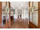 Grand foyer with gleaming hardwood floors, decorative wreaths, and an open layout with views into adjoining rooms at 23 Long Island Pl, Sandy Springs, GA 30328