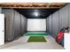Basement golf simulator room with projector screen, turf, and golf club storage for practice at 23 Long Island Pl, Sandy Springs, GA 30328