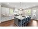 Open kitchen with a large island, granite countertops, stainless steel appliances, and hardwood flooring at 23 Long Island Pl, Sandy Springs, GA 30328