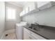 Functional laundry room with modern washer, gray counters, and ample storage space at 23 Long Island Pl, Sandy Springs, GA 30328