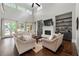Bright living room with high ceilings, fireplace, built-in shelves, and doors leading to the outdoor area at 23 Long Island Pl, Sandy Springs, GA 30328