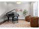 Elegant living room featuring a grand piano, comfortable seating, and plantation shutters at 23 Long Island Pl, Sandy Springs, GA 30328