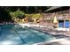 A large pool with a lifeguard chair next to it is surrounded by lush green trees at 23 Long Island Pl, Sandy Springs, GA 30328