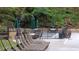 The pool sits at the foot of a greenery-filled hill with lounge chairs for relaxing at 23 Long Island Pl, Sandy Springs, GA 30328