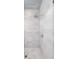 Walk-in shower featuring gray marble tile, rainfall shower head, and glass door at 23 Long Island Pl, Sandy Springs, GA 30328