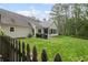 Well maintained backyard features a manicured lawn and mature trees for added privacy at 2297 Ironwood Hill Ct, Dacula, GA 30019