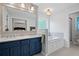 Well-lit bathroom featuring dual sinks, a soaking tub, and separate shower at 2297 Ironwood Hill Ct, Dacula, GA 30019