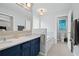 Bright bathroom featuring a double vanity with marble countertop, soaking tub, and tiled floors at 2297 Ironwood Hill Ct, Dacula, GA 30019