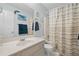 Bathroom featuring a vanity and tiled shower with decorative accents at 2297 Ironwood Hill Ct, Dacula, GA 30019