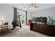 Bedroom featuring a window, exercise bike, and a large desk at 2297 Ironwood Hill Ct, Dacula, GA 30019