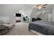 Large bedroom with sloped ceilings, multiple ceiling fans, and an office area at 2297 Ironwood Hill Ct, Dacula, GA 30019