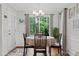 Cozy breakfast nook offers wooded backyard views, with modern chandelier and neutral decor at 2297 Ironwood Hill Ct, Dacula, GA 30019