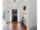 Bright foyer featuring hardwood floors, stylish decor, and a view of the front door at 2297 Ironwood Hill Ct, Dacula, GA 30019
