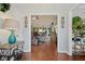 View from the foyer into the living room with hardwood floors, high ceilings, and leather furniture at 2297 Ironwood Hill Ct, Dacula, GA 30019