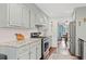 Well-lit kitchen featuring marble countertops, subway tile backsplash, and stainless steel appliances at 2297 Ironwood Hill Ct, Dacula, GA 30019