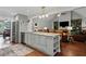 Open kitchen with island seating that overlooks the living room and stainless steel appliances at 2297 Ironwood Hill Ct, Dacula, GA 30019