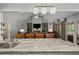 Open concept living area that can be seen from the kitchen with a brick fireplace and lots of seating at 2297 Ironwood Hill Ct, Dacula, GA 30019