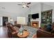 Inviting living room boasts a fireplace, built-in shelving, and plenty of natural light at 2297 Ironwood Hill Ct, Dacula, GA 30019