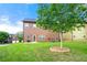 Lush backyard with healthy tree and a well-maintained, two-story home under a bright sky at 3755 Lake Haven Way, Atlanta, GA 30349