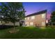 A lush backyard with a healthy tree and a well-maintained, two-story home at 3755 Lake Haven Way, Atlanta, GA 30349