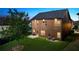 A lush green backyard with a healthy tree and a well-maintained, two-story home at 3755 Lake Haven Way, Atlanta, GA 30349