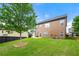 A lush backyard with a healthy tree and a well-maintained, two-story home under a blue sky at 3755 Lake Haven Way, Atlanta, GA 30349