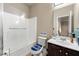 Bathroom with a shower/tub combo, dark wood vanity, and decorated toilet seat at 3755 Lake Haven Way, Atlanta, GA 30349