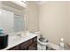 Well-lit bathroom with a single sink vanity, a shower with glass doors, and a modern toilet at 3755 Lake Haven Way, Atlanta, GA 30349