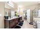 Bright bathroom features double vanity with white countertops, dark wood cabinets, and a large mirror at 3755 Lake Haven Way, Atlanta, GA 30349