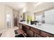 Bright bathroom features double vanity with white countertops, dark wood cabinets, and a large mirror at 3755 Lake Haven Way, Atlanta, GA 30349
