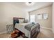 Cozy bedroom with a dark wood bed frame, neutral bedding, and a side table with decorative accents at 3755 Lake Haven Way, Atlanta, GA 30349