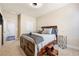 Bedroom featuring a bed with a storage step stool, neutral walls, and carpeted flooring at 3755 Lake Haven Way, Atlanta, GA 30349