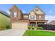 Inviting two-story home with stone details, neat landscaping, and a two-car garage at 3755 Lake Haven Way, Atlanta, GA 30349