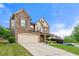 Attractive two-story home with stone features, sloping yard, and a two-car garage at 3755 Lake Haven Way, Atlanta, GA 30349