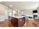 Open-concept kitchen island with seating, dark wood cabinets, and hardwood flooring at 3755 Lake Haven Way, Atlanta, GA 30349