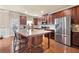 Spacious kitchen with dark wood cabinets, granite countertops, and stainless steel appliances at 3755 Lake Haven Way, Atlanta, GA 30349