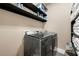 Laundry room includes side-by-side washer and dryer with shelf and storage at 3755 Lake Haven Way, Atlanta, GA 30349
