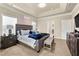 Primary bedroom featuring a luxurious upholstered headboard, sitting bench, and neutral color scheme at 3755 Lake Haven Way, Atlanta, GA 30349